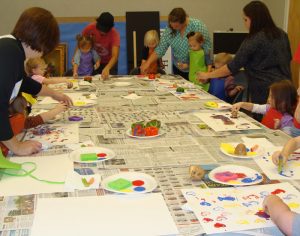 Children and parents painting with vegetable stamps